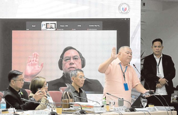 Duterte-rode-1 Former Police Colonel Eduardo Acierto (in dark shirt) takes his oath via recorded Zoom during the 10th Quad Comm hearing held at the House of Representatives. He claimed that a P50-million bounty on his head was placed after implicating two Chinese friends of then president Rodrigo Duterte in the narcotics trade.