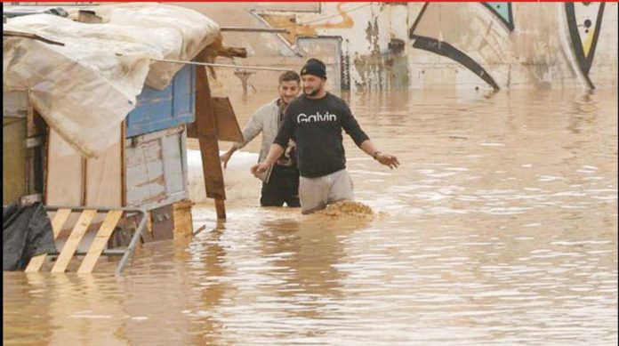 Spain_1_resized Men wade through murky floodwaters in southeastern Spain. More than a year’s worth of rain fell in just eight hours, local officials say. BBC