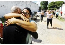 Venezuela frees over 100 arrested after disputed polls Two people are seen embracing tightly on a street in Tocuyito, Venezuela, with a group of people walking in the background and cars parked along the road. Venezuela released over 100 people arrested following July’s contested presidential election. REUTERS