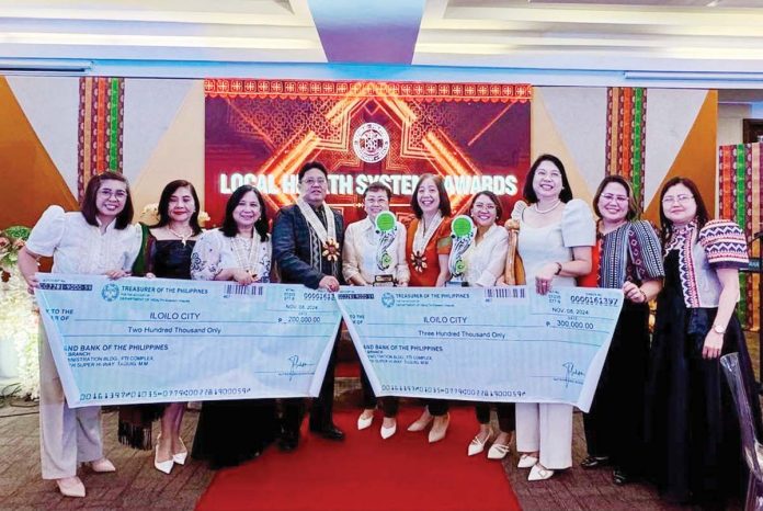 AWARD-WINNING HEALTH INITIATIVES. Iloilo City Health Office (CHO) chief Dr. Anabelle Tang proudly leads the CHO Team in receiving the multiple awards given to Iloilo City for the city’s excellent initiatives in public health from the Department of Health – Western Visayas headed by Dr. Adriano Suba-an.