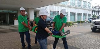 Simulating an earthquake-related medical emergency, rescuers move an injured patient out of the Iloilo Provincial Capitol during yesterday’s earthquake drill. IME SORNITO/PN