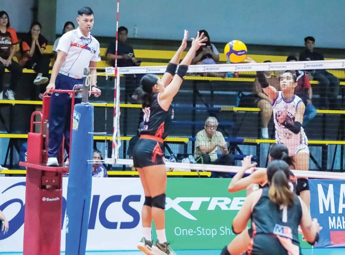 sports-Caparal Negros-ICC Blue Hawks’ Andrea Caparal tries to score against a Quezon Province Tangerines’ player. MPVA PHOTO