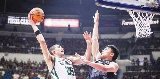 De La Salle University Green Archers’ Michael Phillips tries to score against the defense of University of the Philippines Fighting Maroons’ Jacob Bayla. UAAP PHOTO