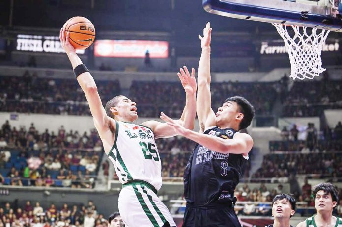 sports-DLSU De La Salle University Green Archers’ Michael Phillips tries to score against the defense of University of the Philippines Fighting Maroons’ Jacob Bayla. UAAP PHOTO