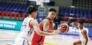 NorthPort Batang Pier’s Arvin Tolentino protects the ball from the defense of NLEX Road Warriors’ Xyrus Torres. PBA PHOTO