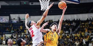 University of Santo Tomas Growling Tigers’ Angelo Crisostomo goes for a tough basket against the defense of University of the East Red Warriors’ Devin Fikes. UAAP PHOTO