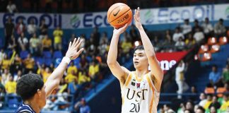 University of Santo Tomas Growling Tigers’ Amiel Acido pulls up for a three-pointer against the defense of Adamson University Falcons’ AJ Fransman. UAAP PHOTO