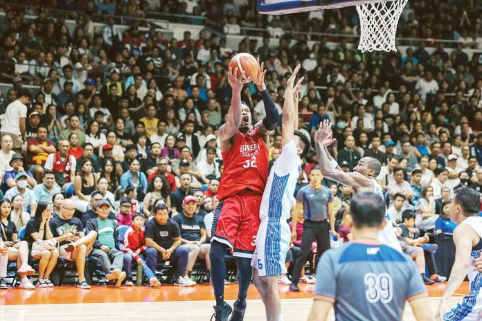 sports_PBA_resized Barangay Ginebra San Miguel Kings’ Justin Brownlee shoots over the defense of TNT Tropang Giga's Rey Nambatac. PBA PHOTO