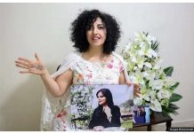 Jailed Iranian Nobel winner temporarily freed Narges Mohammadi Narges Mohammadi, wearing a white dress with flower patterns on it, holds out her right hand to show a message written on it, while holding a photo in her left hand. The photo is Mahsa Amini, whose death in custody triggered protests in Iran. Narges Mohammadi Photo