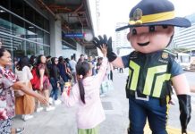 A mascot of the Philippine National Police greets a child with a high five outside the Parañaque Integrated Terminal Exchange on Oct. 31, 2024. The Land Transportation Franchising and Regulatory Board on Thursday, Dec. 19, 2024, said it issued 956 special permits to public utility vehicles (PUV), increasing the number of available PUVs such as buses in routes that will be particularly busy during the holiday season. PNA PHOTO BY AVITO DALAN