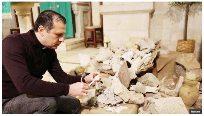 Palestine_1_resized A baby Jesus figure is placed on top of a pile of rubble in Bethlehem’s Evangelical Lutheran Church, with sermons focusing on the Gaza war. REUTERS