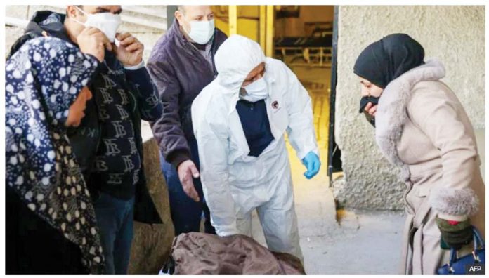 Syria-1 Relatives retrieved some of the bodies found at Harasta hospital in Syria after they were identified. AFP