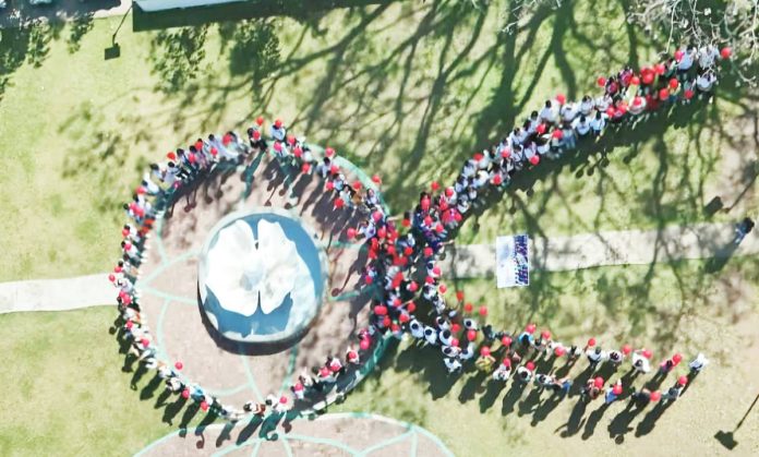 ime HIV On December 4, the Iloilo Provincial Health Office, in collaboration with the Concepcion local government unit, commemorated World AIDS Day with the theme, “Take the Rights Path.” The event gathered students, teachers, barangay officials, and stakeholders to promote an inclusive approach to combating HIV/AIDS. Photo shows the participants forming a large human red ribbon. The red ribbon is a global symbol of awareness and support for people living with HIV/AIDS. Photo from Iloilo Provincial Health Office Facebook Page