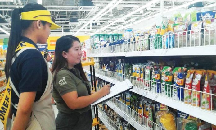 ime rush 1 An inspector from the Department of Trade and Industry checks the prices of noche buena products at a supermarket in Iloilo City. DTI REGION 6 PHOTO