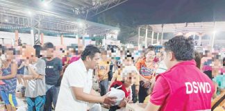 People dislocated by the eruption of Mount Kanlaon in Negros Occidental receive food packs from the Department of Social Welfare and Development - Region 6. Photo shows some of the evacuees at a covered gym in Barangay Robles, La Castellana, Negros Occidental. DSWD-6 PHOTO