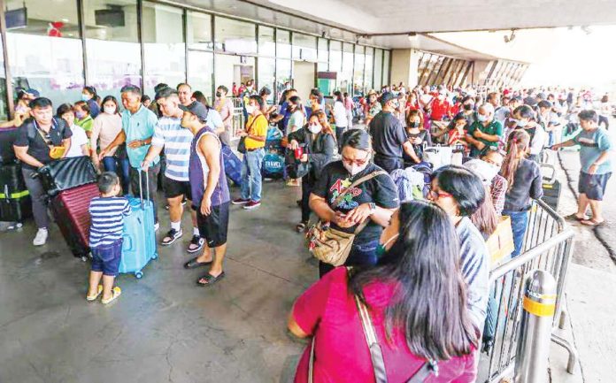 no_repeat_1_resized Hundreds of stranded passengers crowd the Ninoy Aquino International Airport Terminal 1 in Pasay City after hundreds of flights were cancelled, delayed or diverted on New Year's Day, Jan. 1, 2023. “Technical issues” at the air navigation facilities of the Civil Aviation Authority of the Philippines prompted the cancellation of local and international flights, according to the Department of Transportation. GERARD CARREON PHOTO
