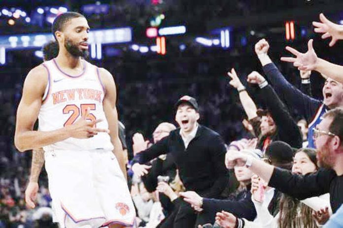 sports-Bridges New York Knicks’ Mikal Bridges gestures after making a three-pointer.
