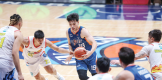 Meralco Bolts’ Kier John Quinto protects the ball from the defense of Rain or Shine Elasto Painters’ Jhonard Clarito. PBA PHOTO