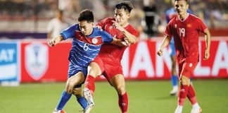 Philippine men’s football team’s Sandro Reyes tries to control the ball while being defended by a Vietnam player. GETTY IMAGES