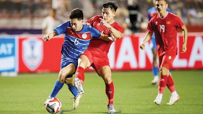 sports-PH-1 Philippine men’s football team’s Sandro Reyes tries to control the ball while being defended by a Vietnam player. GETTY IMAGES