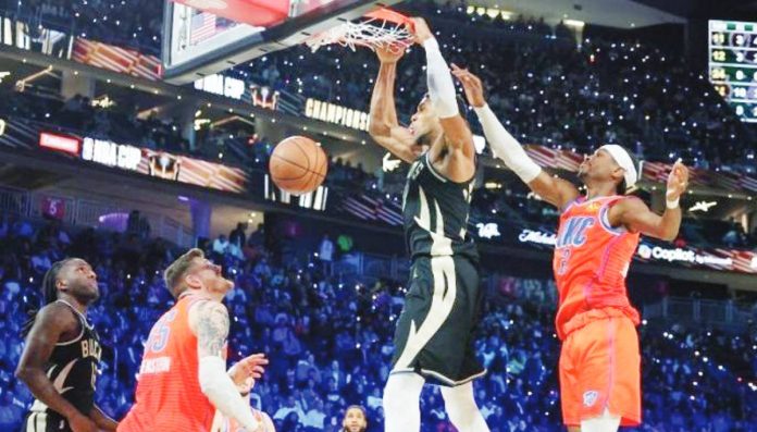 sports_Mil_1_resized Giannis Antetokounmpo of Milwaukee Bucks dunks ahead of Shai Gilgeous-Alexander of Oklahoma City Thunder. GETTY IMAGES