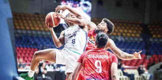 Converge FiberXers’ Deschon Winston is clobbered by the defense of Phoenix Fuel Masters’ Donovan Smith as he goes for an inside hit. PBA PHOTO