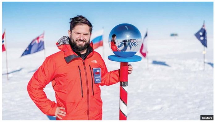 Chile-1 Chilean President Gabriel Boric poses next to the Ceremonial Pole Globe during his historic visit to the South Pole in Antarctica, on January 3, 2025. REUTERS
