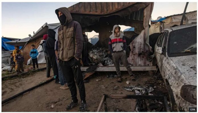 Gaza_resized People inspect damage after an Israeli air strike reportedly killed 11 people at a tent camp for displaced families in al-Mawasi, southern Gaza. Israel has attacked heavily populated areas, saying Hamas militants hide among displaced civilians. EPA