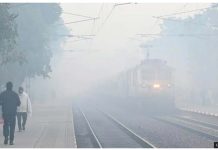 Smog causes chaos in Indian capital Delhi Commuters walk on railway tracks wearing caps and jackets as a train arrives amid fog at Shahabad Mohammadpur railway station in the morning winter chill and fog in New Delhi, India. Dozens of flights and trains have been delayed due to bad weather conditions. GETTY IMAGES