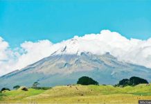 New Zealand mountain gets same legal rights as a person New Zealand’s Mount Taranaki is seen surrounded by cloud and in front of a green. Mount Taranaki is considered sacred and an ancestor of the local Māori people. GETTY IMAGES