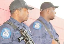 Trinidad and Tobago declares emergency as murders soar Two armed policemen in Port of Spain, Trinidad, seen in profile wearing black baseball caps and blue shirts. GETTY IMAGES
