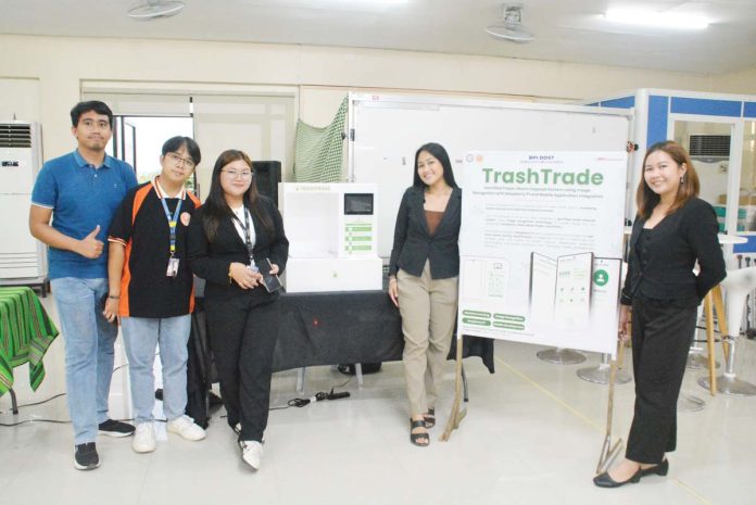 WVSU-students-waste-disposal-1 TURNING TRASH INTO TREASURE. The TrashTrade team from West Visayas State University in Iloilo City combines innovation and sustainability, transforming waste management into a community-driven, tech-powered solution for a cleaner, greener future. From left to right: Prof. John Christopher Mateo, Wilmer Suelo, Kyla Joy Trompeta, Andrea Bea Quirante, and Narisz Khyll Binalber. PHOTOS BY DUNDEE BALATAYO, WVSU