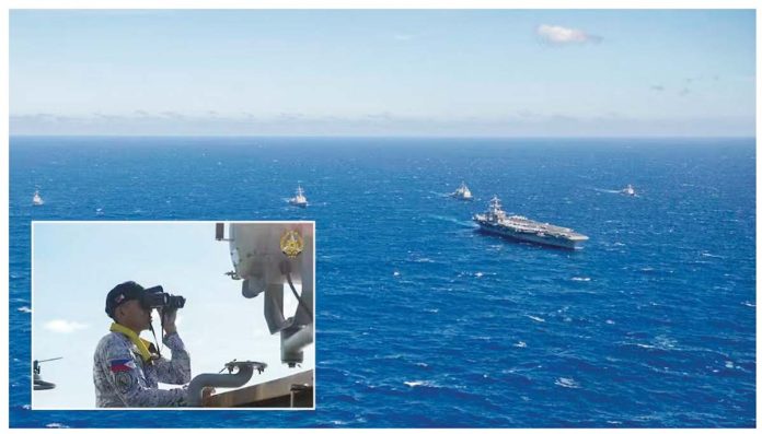 West-PH-Sea-1 An officer of the Philippine Navy (inset) observes the nuclear-powered aircraft carrier USS Carl Vinson (CVN-70) sailing in formation, together with other vessels of the Philippine Navy and the US Navy, during a joint patrol or “maritime cooperative activity” off Palawan on January 17, 2025. PHOTOS FROM US NAVY AND PAOAFP
