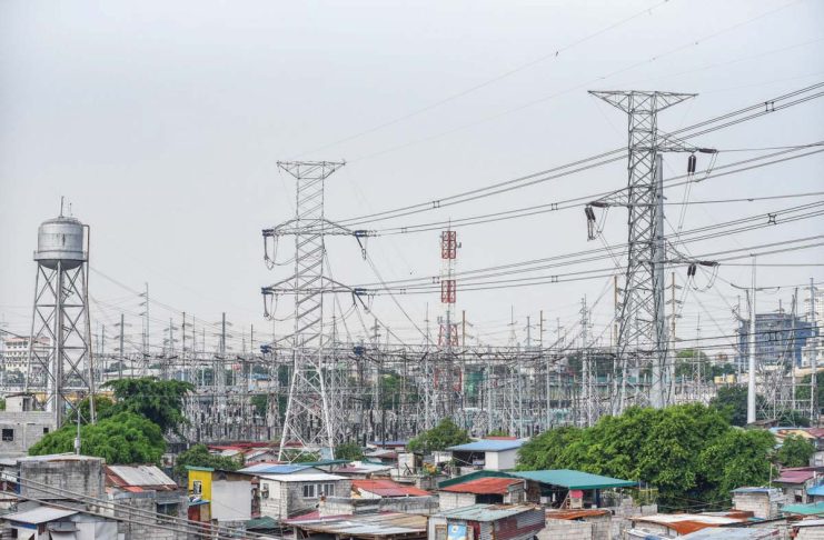 High voltage towers that support transmission lines for electrical power distribution in the Luzon grid is seen from a residential area in Baesa, Quezon City. MARIA TAN, ABS-CBN NEWS PHOTO