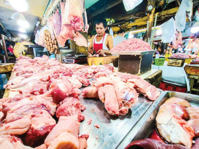 pork_prices_1_resized A vendor has an abundant supply of different pork meat and other by-products at a market in Quezon City on Jan. 14, 2025. PNA PHOTO BY JOAN BONDOC