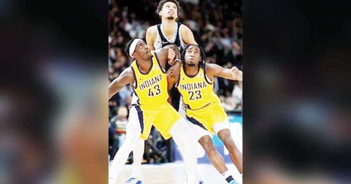 sports-NBA-1_superimposed Indiana Pacers’ Paskal Siakam and Aaron Nesmith try to box out San Antonio Spurs center Victor Wembanyama. GETTY IMAGES
