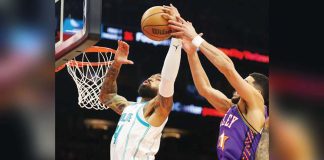 Nick Richards, then of Charlotte Hornets, grabs the rebound away from Phoenix Suns guard Devin Booker during the second half of their January 12 game at Footprint Center in Phoenix, Arizona. Photo courtesy of Mark J. Rebilas-Imagn Images
