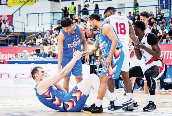 sports-Sagesse-1 Sam Deguara is picked up by his Zamboanga Valientes’ teammates after going down with a hit from an opponent. PHOTO COURTESY OF DUBAI BASKETBALL CHAMPIONSHIP