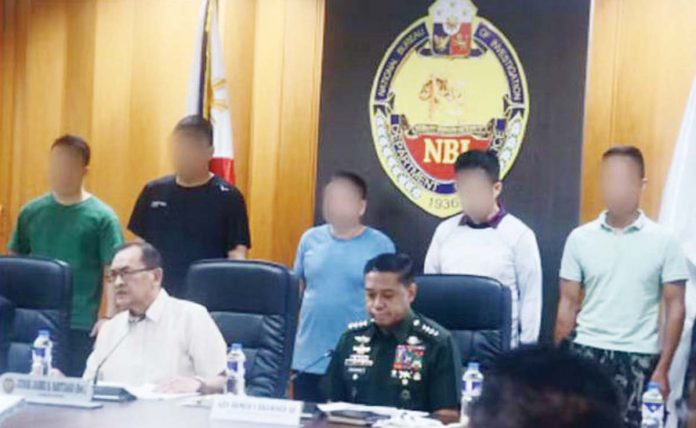 Alleged_Chinese_1_resized National Bureau of Investigation director Jaime Santiago and Armed Forces of the Philippines chief Gen. Romeo Brawner (both seated) on Jan. 30 presentED the five alleged Chinese spies arrested during operations in various locations from Jan. 24 to 25. The five were accused of engaging in intelligence, surveillance, and reconnaissance operations using sophisticated equipment. PNA