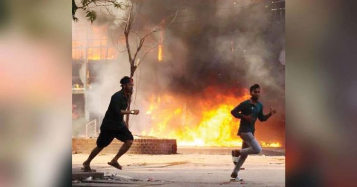 Bangladesh Two men are seen running on the road in Bangladesh. Behind them is a store in flames. Last year’s violence was the worst the country had seen since its 1971 war of independence. GETTY IMAGES
