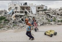 Hamas: No talks unless Israel releases prisoners Palestinian children walk past destroyed buildings and makeshift shelters in Beit Lahia, northern Gaza. GETTY IMAGES