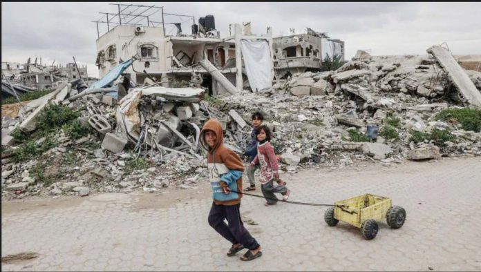 Gaza_1_resized Palestinian children walk past destroyed buildings and makeshift shelters in Beit Lahia, northern Gaza. GETTY IMAGES