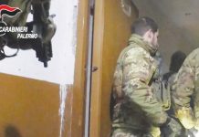 Italian police arrest 181 in bid to stop Mafia rebuilding in Sicily Two uniformed officers of the Carabinieri wearing jackets with a camouflage print stand in a doorway while a colleague behind them holds a gun. Italy's military police launched the operation in the early hours of Tuesday against the Mafia. CARABINIERI PALERMO