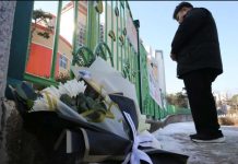 Korean teacher stabs eight-year-old girl A man stands with his hands crossed in front of a school gate. Bouquets of flowers lay on the ground beside him. Locals laid flowers at the school’s gate to mourn an eight-year-old student. NEWS1
