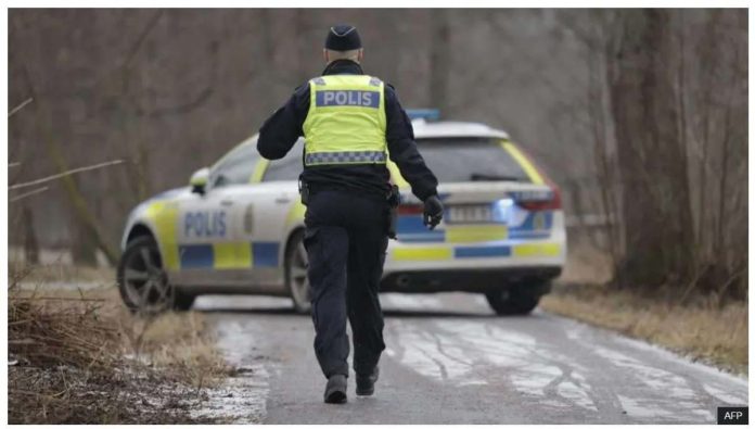 Sweden_resized A police officers walks towards a police vehicle near the Risbergska School in Orebro, Sweden, on February 4, 2025, following reports of a serious violent crime. The attack in Orebro has been described as the “worst mass shooting in Swedish history”. AFP