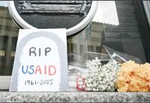 Experts warn of threat to global health as US freezes overseas aid A sign placed reading “RIP USAID 1961-2925” and flowers are placed beneath the covered seal of the US Agency for International Development headquarters in Washington, DC. AFP