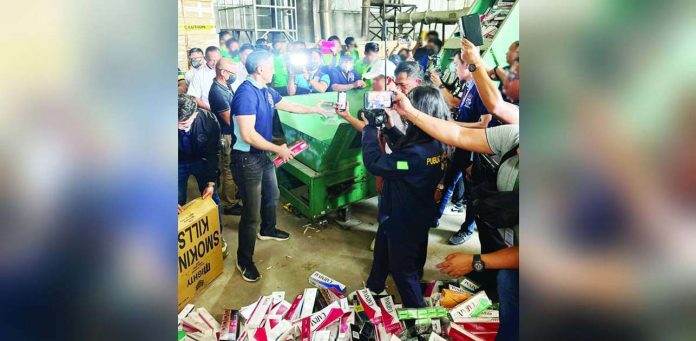 cigarettes_superimposed Bureau of Internal Revenue Commissioner Romeo Lumagui Jr. leads the destruction of seized illicit cigarettes in Porac, Pampanga on Monday, Feb. 24, 2025. ROMEO “JUNE” LUMAGUI JR./FACEBOOK PHOTO