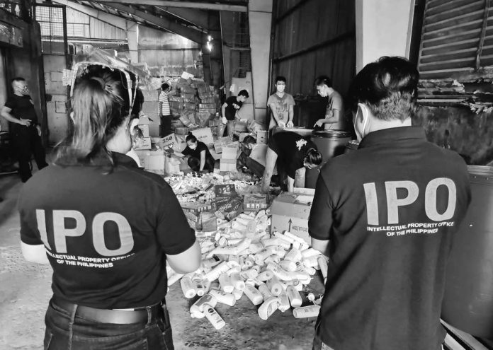 fake_goods_resized IPOPHL’s IEO joins the Bureau of Customs in destroying counterfeit items in a Bulacan warehouse in July 2021. Estimated at P2 billion, the seized items include brands such as Nike, Adidas, Lacoste, Gucci, Victoria’s Secret, Jo Malone, Clinique and Dior, among others. INTELLECTUAL PROPERTY OFFICE OF THE PHILIPPINES FILE PHOTO