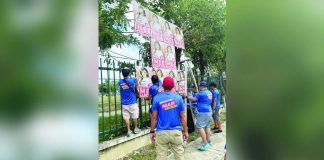 Commission on Elections personnel remove oversized campaign posters of re-electionist Sen. Imee Marcos during an “Operation Baklas” in Iloilo City. The campaign materials are found to violate posting regulations as part of efforts to ensure compliance with election laws ahead of the May 2025 elections.