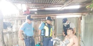 Iloilo Province’s No. 3 most wanted man, Romy Porras Pancrudo (sitting), was arrested on Wednesday, Feb. 25, 2025, in Cabatuan town. CABATUAN MPS PHOTO